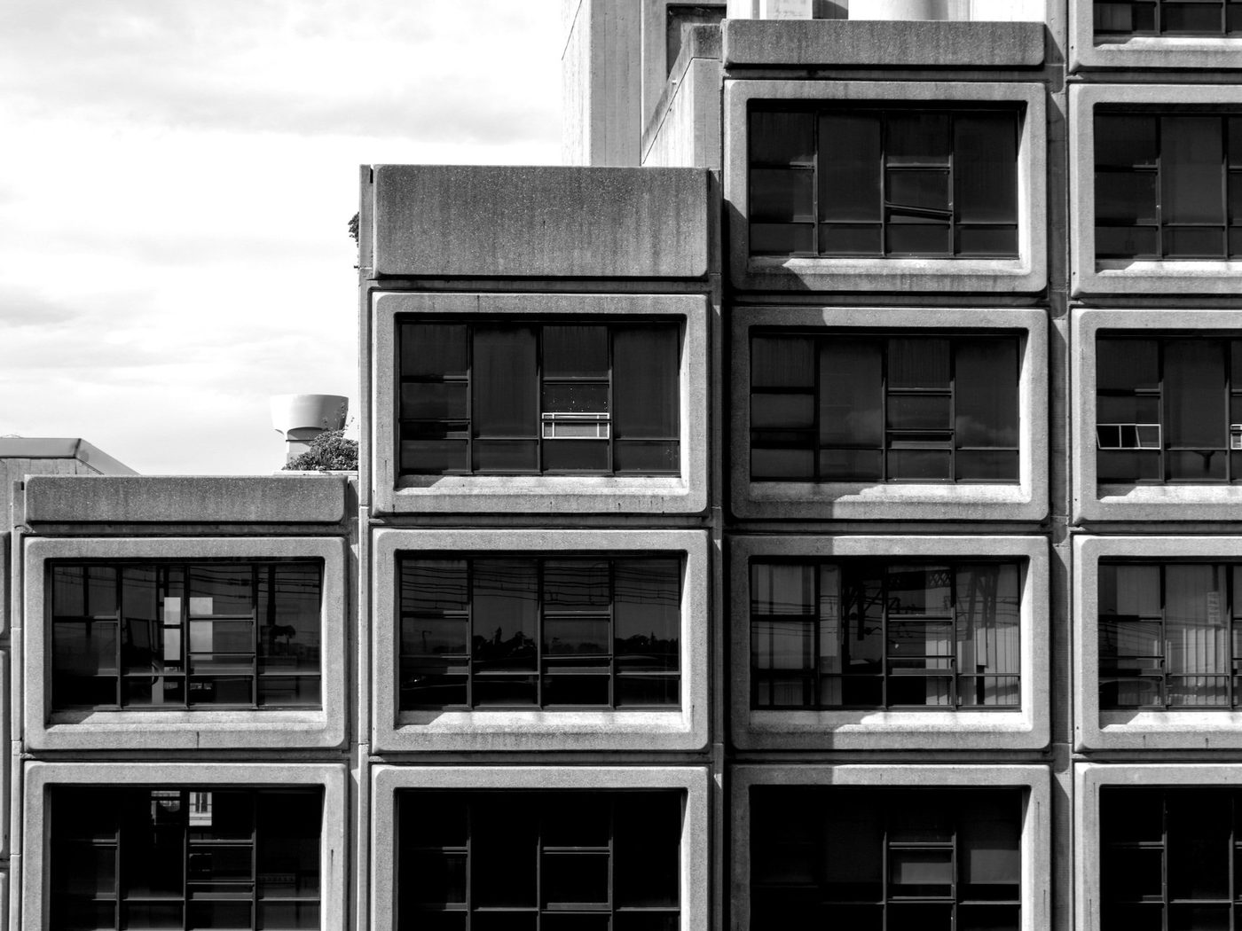 Black and white image of multi level apartment building.