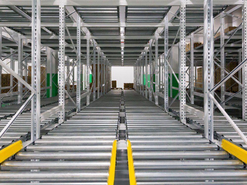 Metal rollers framed by a metal structure to move boxes around a distribution area.